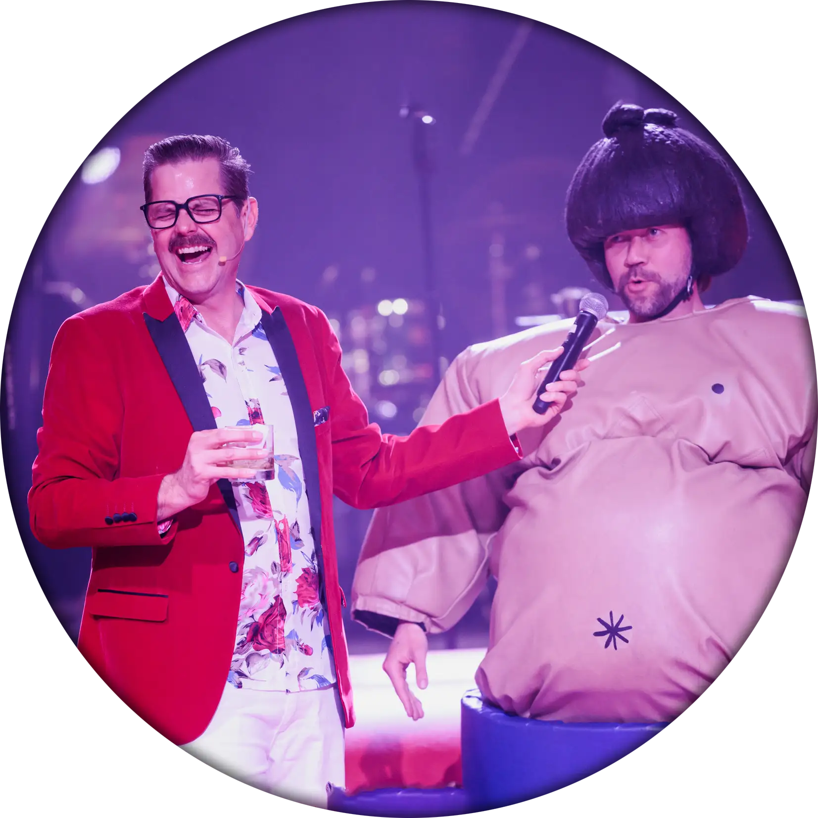 Cliff interviewing a person in a sumo wrestler costume