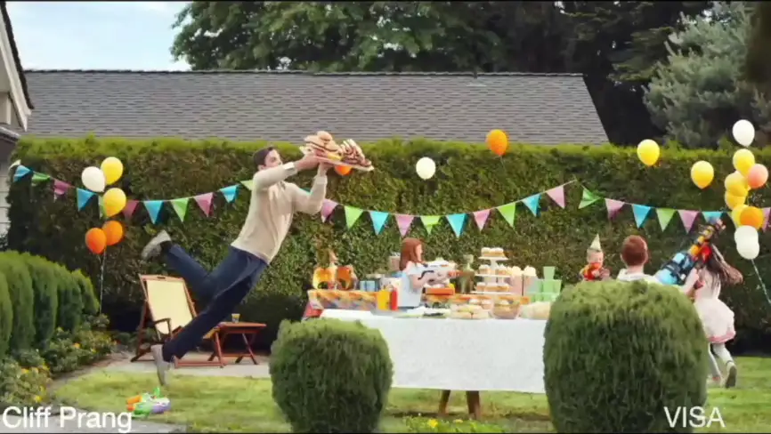 Cliff flying through the air at a party towards a table full of food