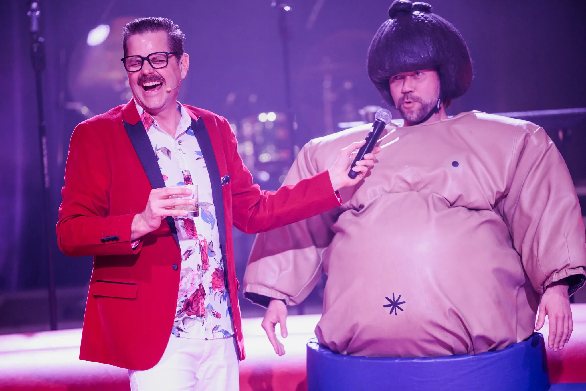 Cliff hosting a sumo event 