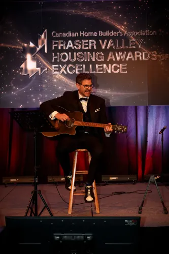 Cliff in a suit with his guitar engaging the audience