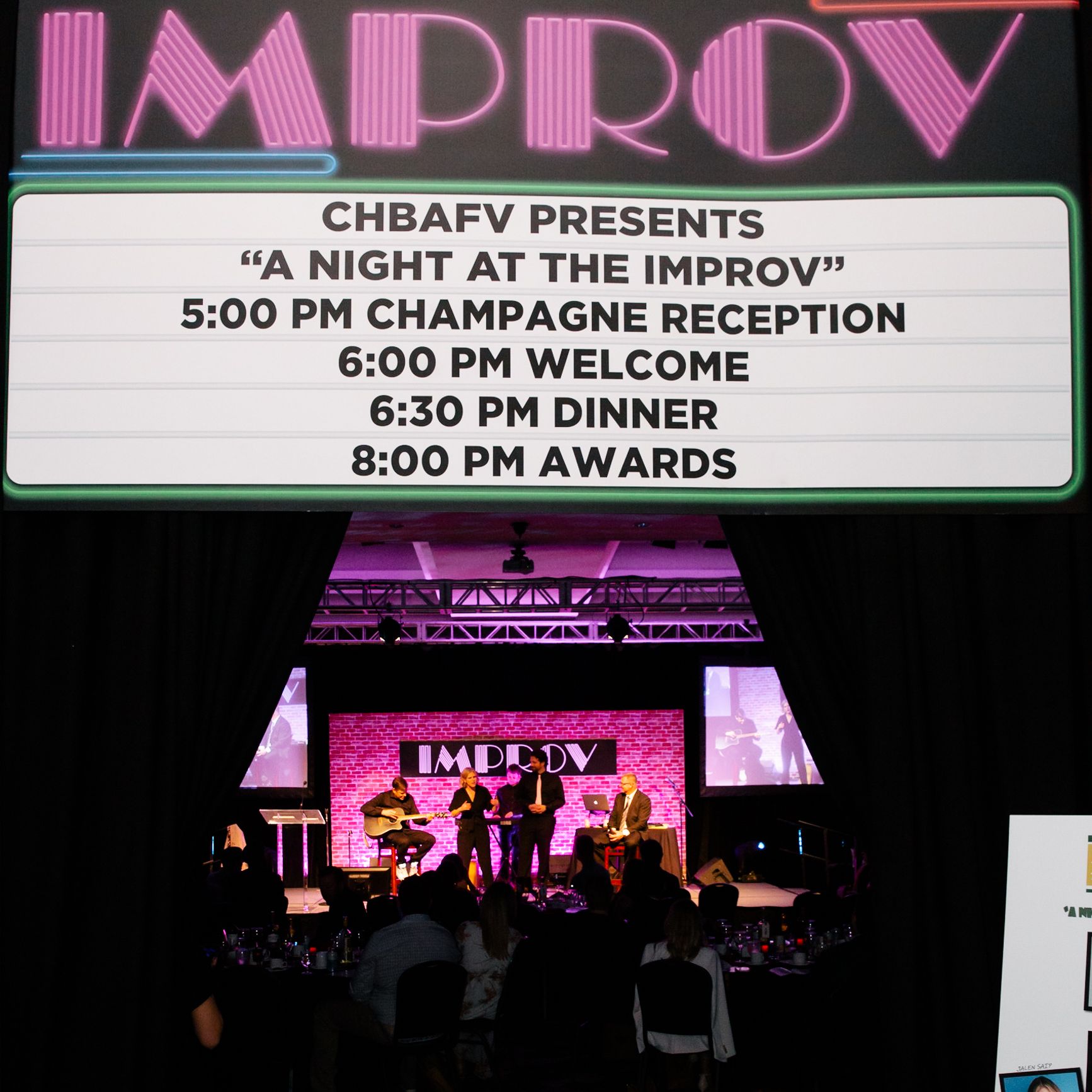 Improv group with retro sign above introducing "A Night at the Improv"