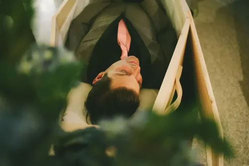 Cliff in a suit in a pine casket