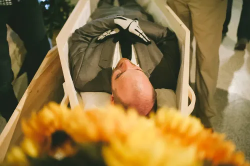 Scott wearing a suit in a pine casket