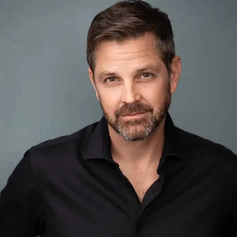 Photo of Cliff in a black collared shirt