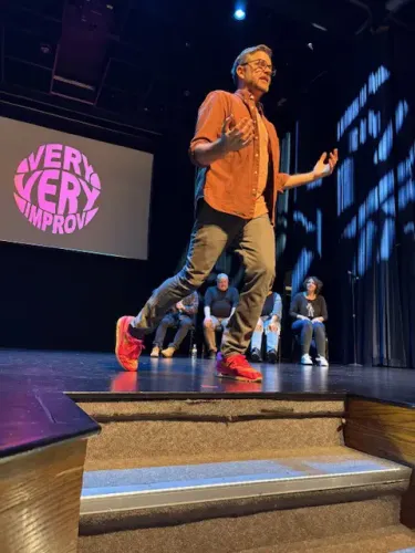 Cliff on stage performing at an improv show