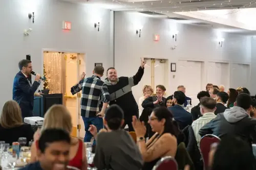 Cliff emceeing as attendees participate in games at the Cascadia Christmas Party