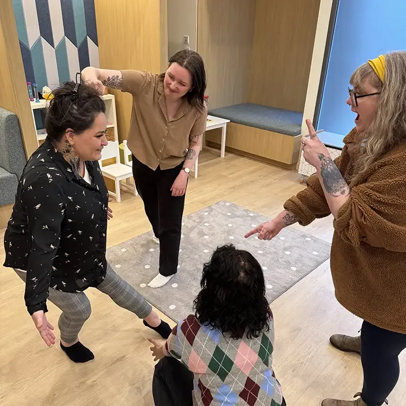 A group at a workshop performing different movements 