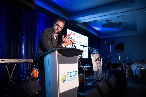 Cliff at the mic clapping as Emcee at an EOCP event.