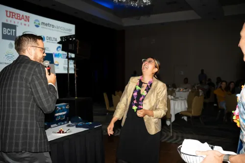 Cliff as emcee interviewing an individual who is laughing