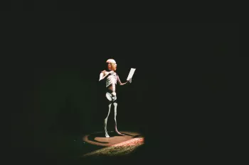Scott in a skeleton suit as he reads out prostate poetry