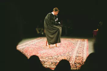 Cliff sitting on stool being a reverend
